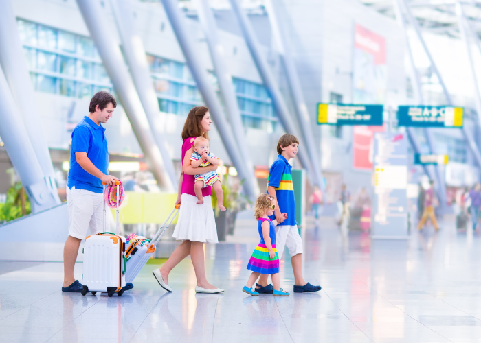 Family walking down the airport during their family vacation