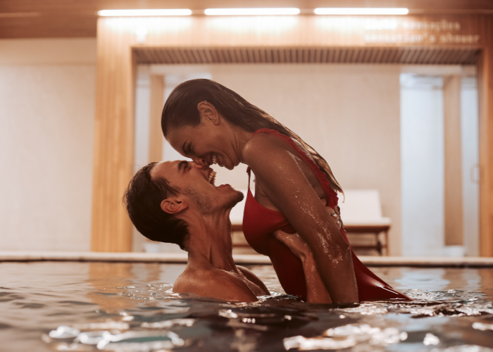 A couple enjoying in a pool in an adults only resort