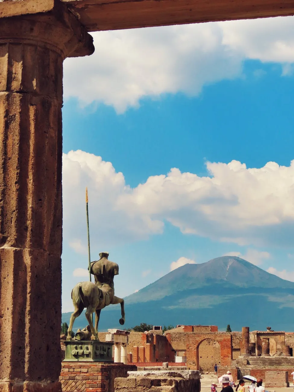 a statue of a horse and rider in front of a mountain in Pompeii