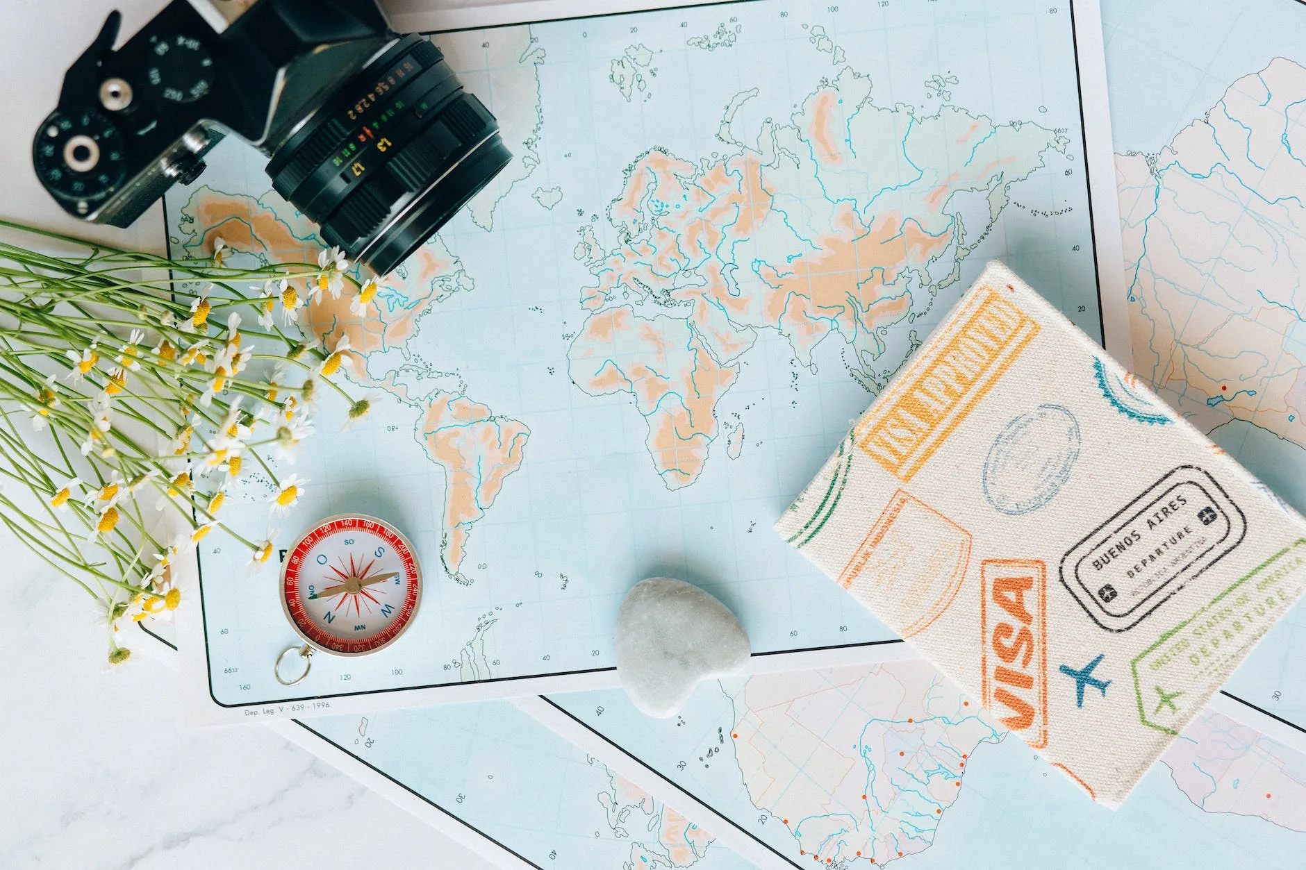 29 Things Not to Do in Italy: Avoid These Mistakes 18 overhead shot of a camera and flowers near a map