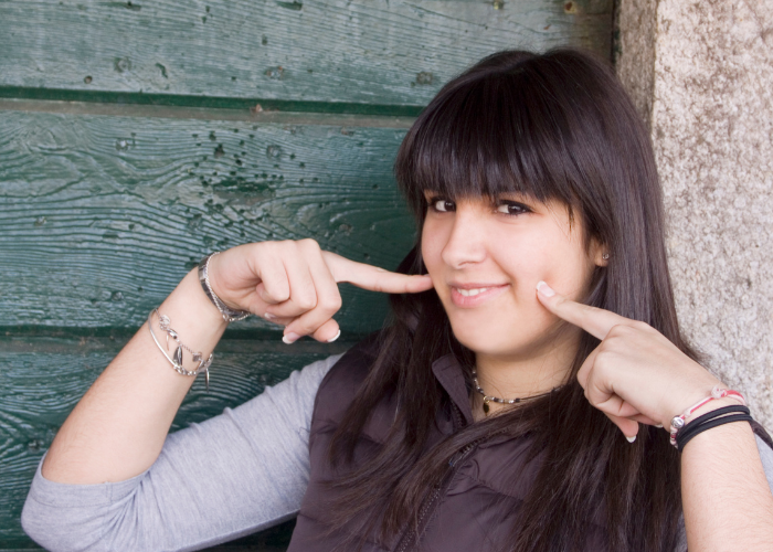 woman doing the Italian gesture to express food is good touching both cheeks