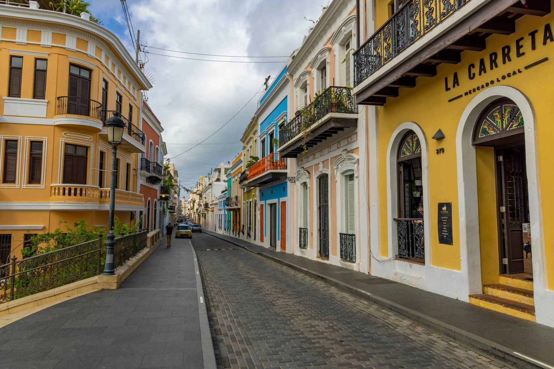 Solo Female Travel Blog | Traveleira – Inspiring Women to Travel 5 view of a cobblestone street between colorful buildings in san juan puerto rico
