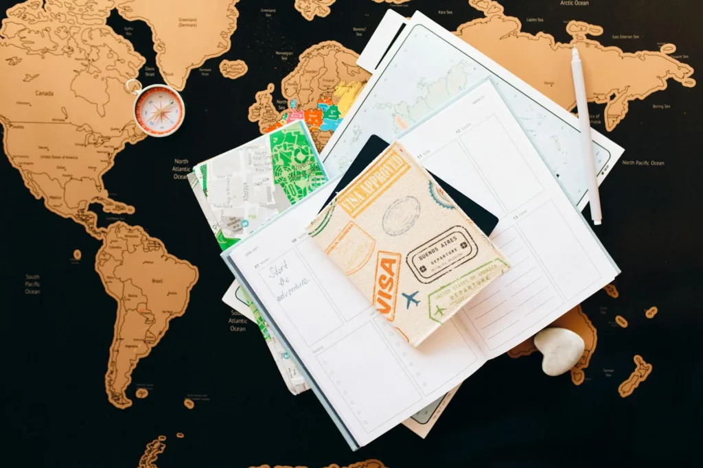 How To Plan A Trip To Europe in 2026: Ultimate Guide 2 passport on top of a planner