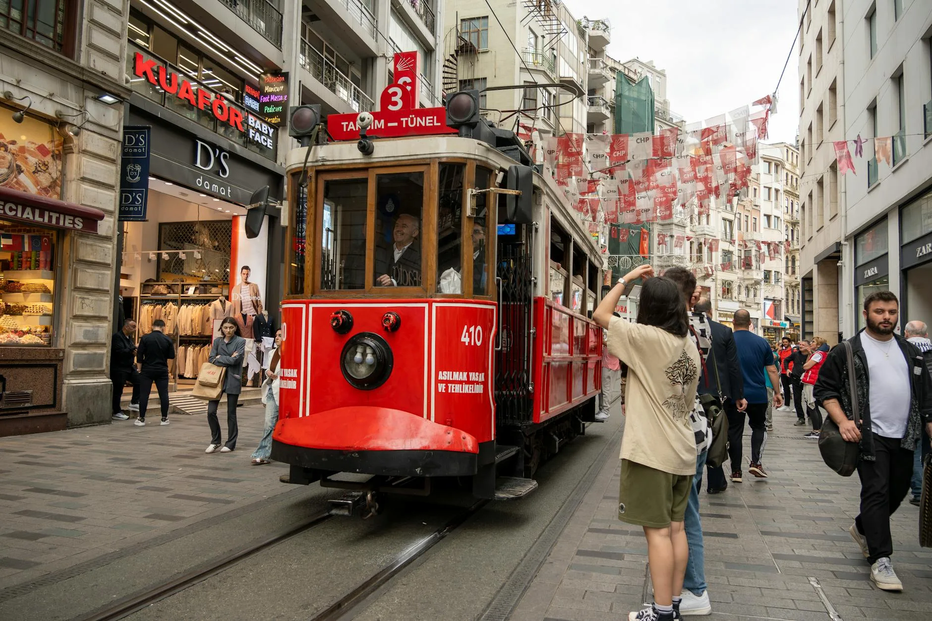 What is Mass Tourism? 5 Tips to Not Be Part of the Problem 1 people around vintage tram on cicek pasaji in istanbul in turkey